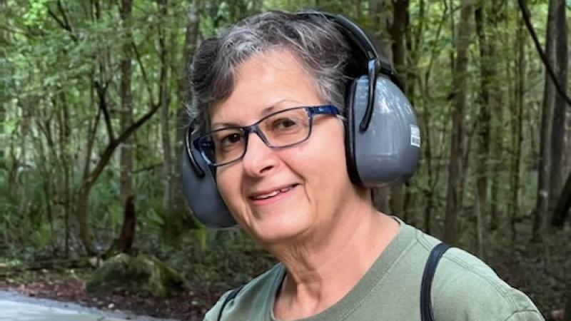 A photo of Julie Lake volunteering at Devils Millhopper